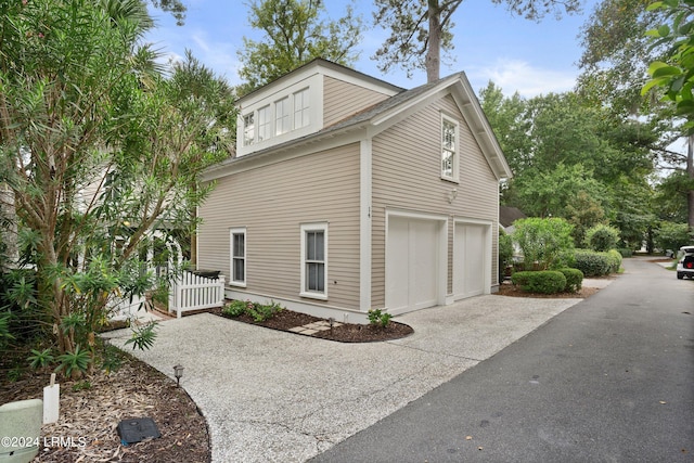 view of side of home with a garage