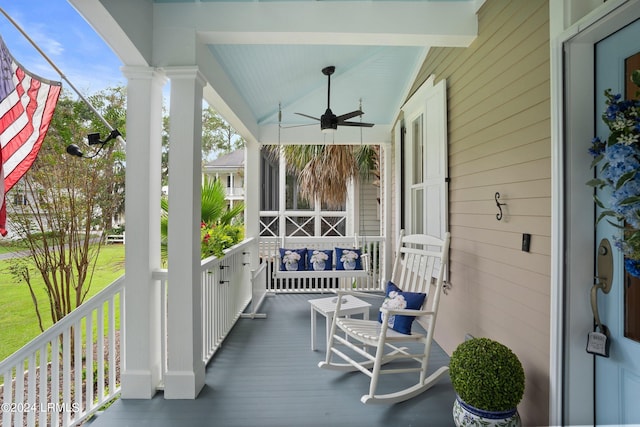 wooden terrace featuring ceiling fan and a porch