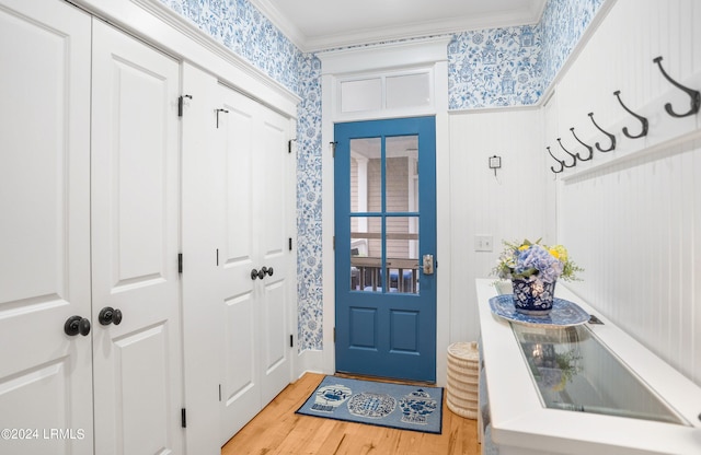 entryway featuring ornamental molding and hardwood / wood-style floors