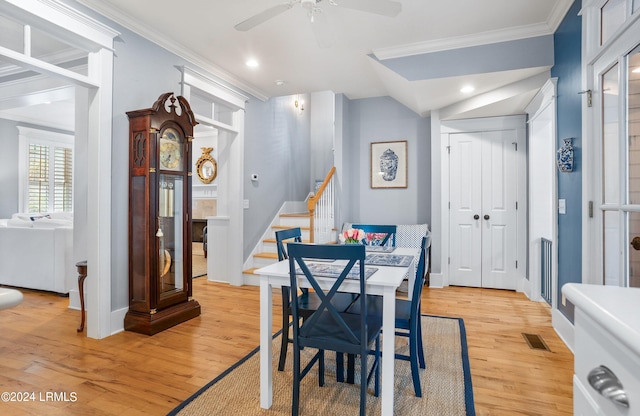 dining space featuring ornamental molding, light hardwood / wood-style floors, and ceiling fan