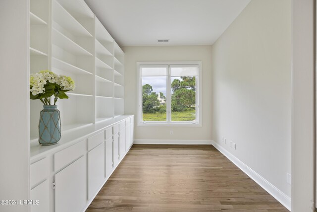 unfurnished dining area featuring hardwood / wood-style floors