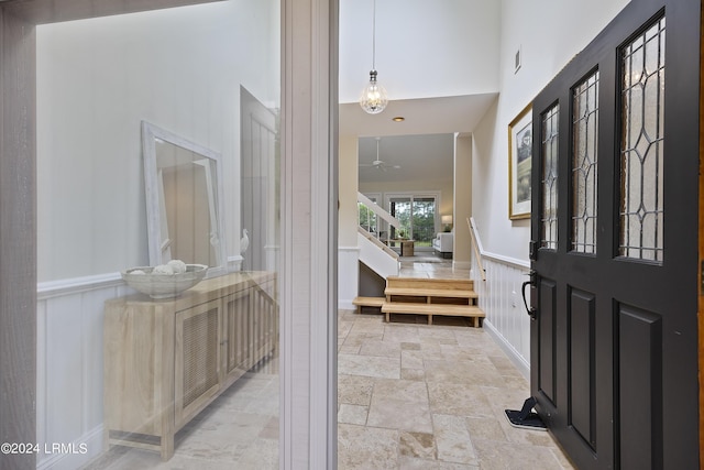 foyer entrance featuring a towering ceiling