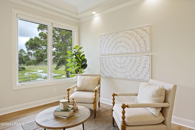 living area with ornamental molding and wood-type flooring