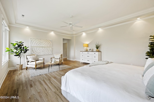 bedroom featuring light hardwood / wood-style flooring, ornamental molding, and ceiling fan