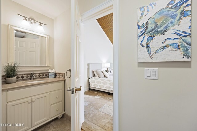 bathroom featuring vanity and decorative backsplash