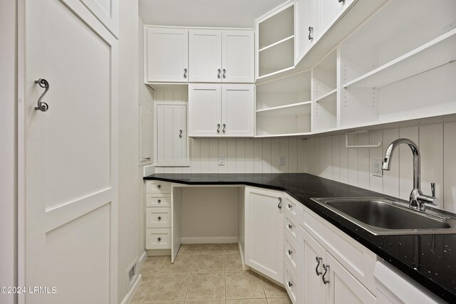 kitchen featuring sink, white cabinetry, tasteful backsplash, light tile patterned floors, and white dishwasher