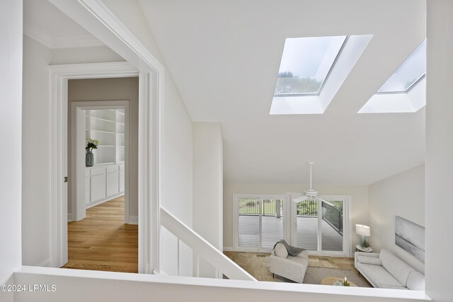 interior space with wood-type flooring and a skylight