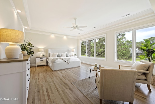 bedroom featuring crown molding, ceiling fan, and light wood-type flooring