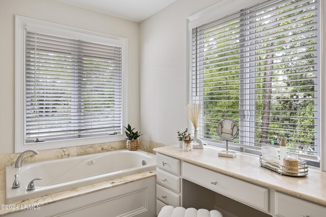 bathroom with vanity and a tub to relax in