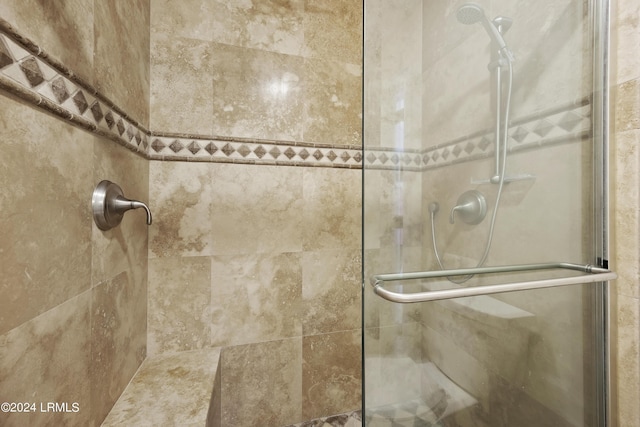 bathroom featuring a shower with shower door