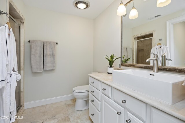 bathroom with vanity, toilet, and an enclosed shower