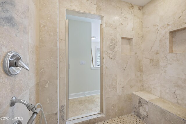 bathroom featuring a tile shower