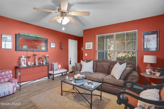 living room featuring ceiling fan and light hardwood / wood-style floors