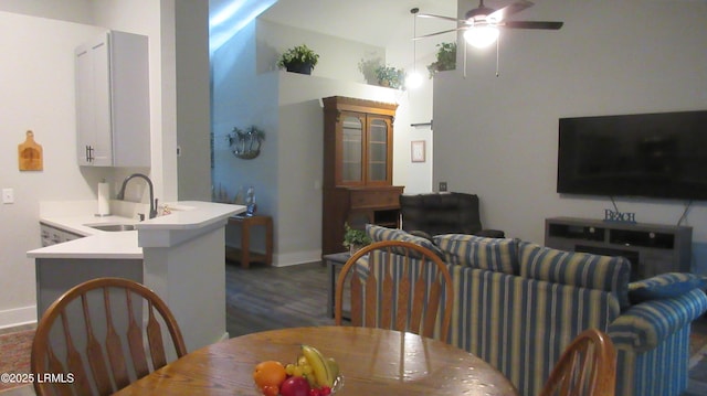 dining space with dark wood-style floors, baseboards, and a ceiling fan