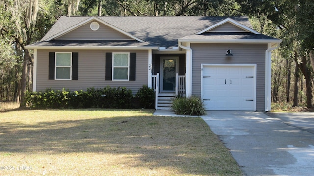 ranch-style home with an attached garage, a shingled roof, concrete driveway, and a front yard