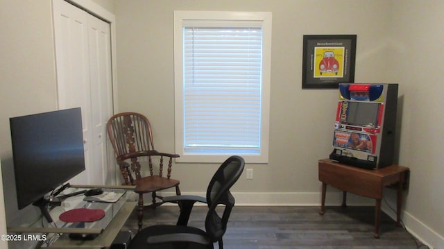 office space with dark wood-style flooring and baseboards