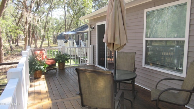 wooden terrace with outdoor dining area