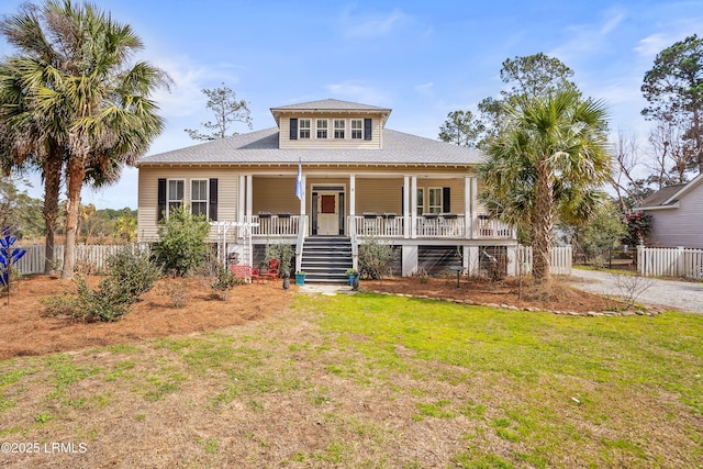 view of front of property featuring a front lawn, stairs, fence, and a porch