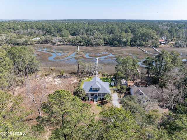 birds eye view of property featuring a water view and a view of trees