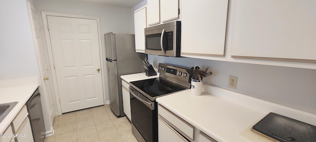 1231 Ladys Island Dr Unit 221, Port Royal, SC 29935 - kitchen featuring stainless steel appliances, white cabinetry, light tile patterned floors, and light countertops