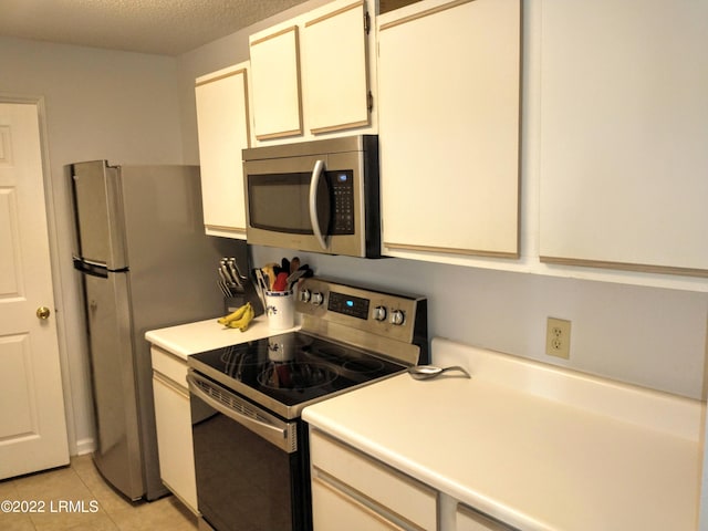 1231 Ladys Island Dr Unit 221, Port Royal, SC 29935 - kitchen with light countertops, light tile patterned flooring, a textured ceiling, and appliances with stainless steel finishes