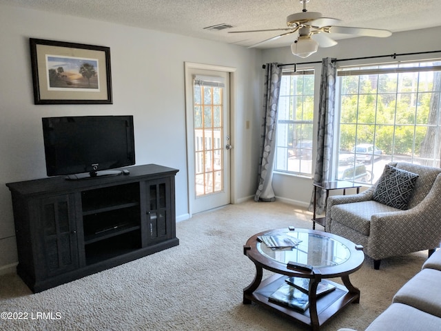 1231 Ladys Island Dr Unit 221, Port Royal, SC 29935 - living room with ceiling fan, a textured ceiling, visible vents, baseboards, and carpet flooring