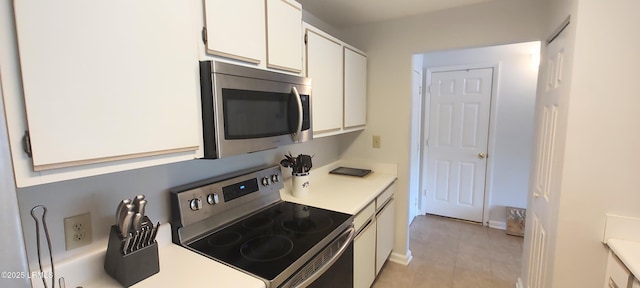 1231 Ladys Island Dr Unit 221, Port Royal, SC 29935 - kitchen with stainless steel appliances, light countertops, white cabinetry, and light tile patterned floors