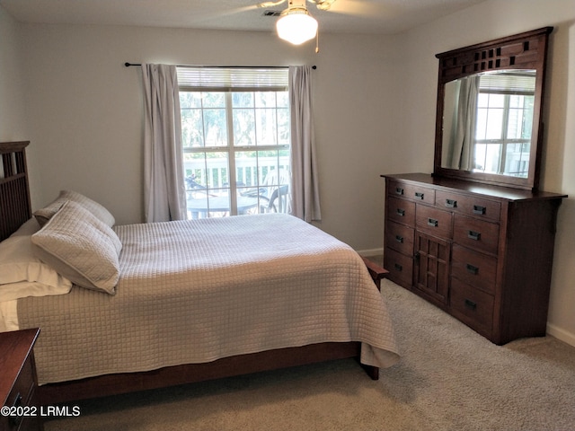 1231 Ladys Island Dr Unit 221, Port Royal, SC 29935 - bedroom with a ceiling fan, baseboards, multiple windows, and light carpet