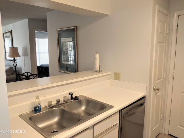 1231 Ladys Island Dr Unit 221, Port Royal, SC 29935 - kitchen with stainless steel dishwasher, white cabinetry, a sink, and light countertops