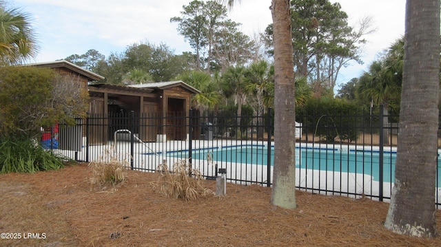 community pool with a patio and fence