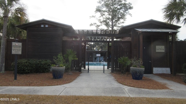 view of community with a swimming pool, fence, and a pergola