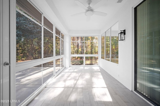 unfurnished sunroom with visible vents and ceiling fan