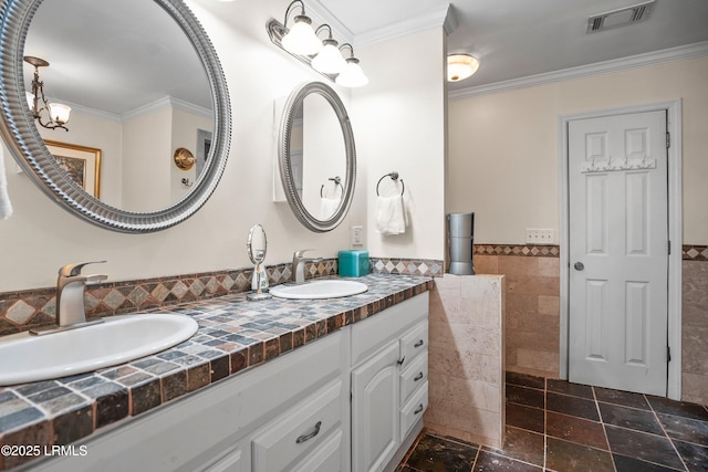 373 Pike Dr, Fripp Island, SC 29920 - full bath with tile walls, double vanity, crown molding, and wainscoting