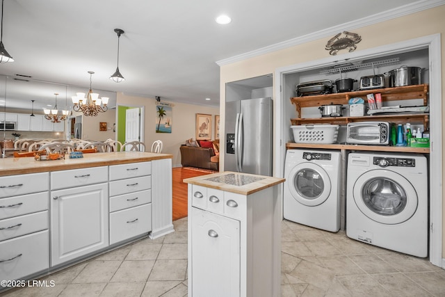 373 Pike Dr, Fripp Island, SC 29920 - laundry area with separate washer and dryer, ornamental molding, a chandelier, light tile patterned floors, and recessed lighting