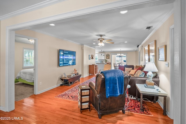 373 Pike Dr, Fripp Island, SC 29920 - living room featuring healthy amount of natural light, light wood-style flooring, a chandelier, ceiling fan, and crown molding