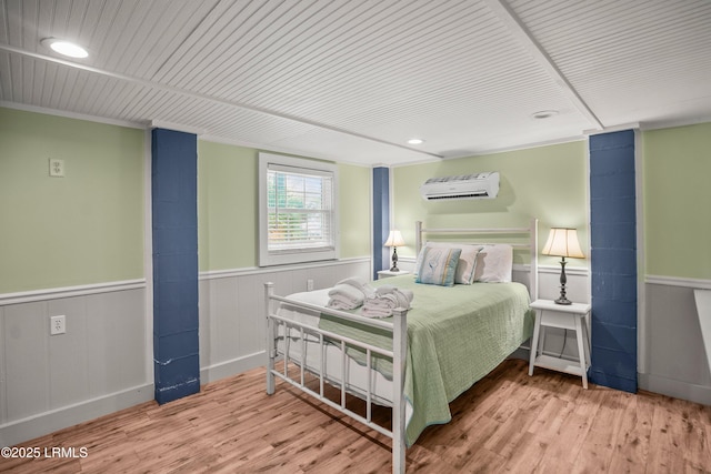 373 Pike Dr, Fripp Island, SC 29920 - bedroom with a wall unit AC, wood finished floors, wainscoting, recessed lighting, and wooden ceiling