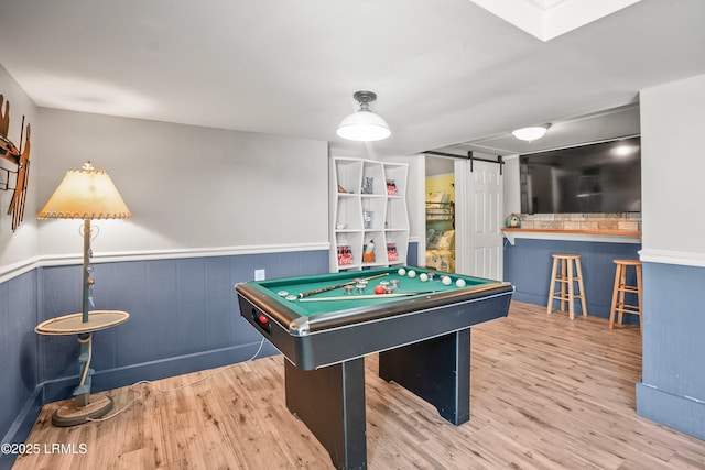 373 Pike Dr, Fripp Island, SC 29920 - playroom with a barn door, a wainscoted wall, wood finished floors, and billiards table