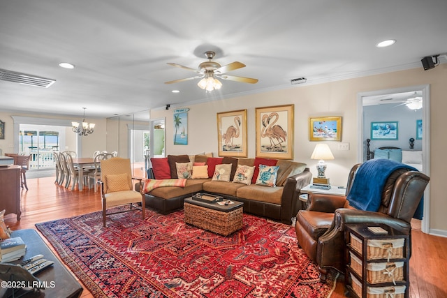 373 Pike Dr, Fripp Island, SC 29920 - living room featuring a ceiling fan, a chandelier, wood finished floors, recessed lighting, and ornamental molding