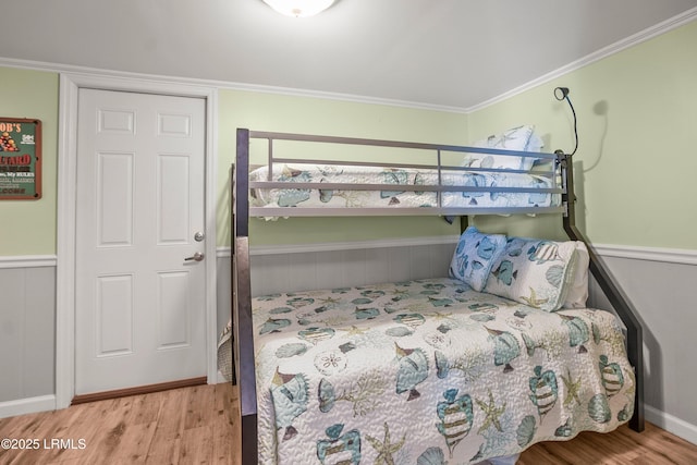 373 Pike Dr, Fripp Island, SC 29920 - bedroom with wood finished floors, wainscoting, and ornamental molding