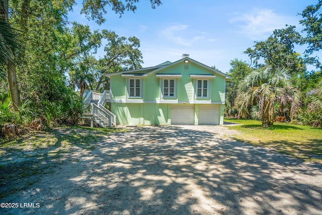373 Pike Dr, Fripp Island, SC 29920 - view of front of property featuring stairs, dirt driveway, and an attached garage