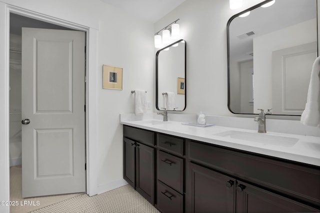 full bath featuring double vanity, a sink, tile patterned flooring, and visible vents