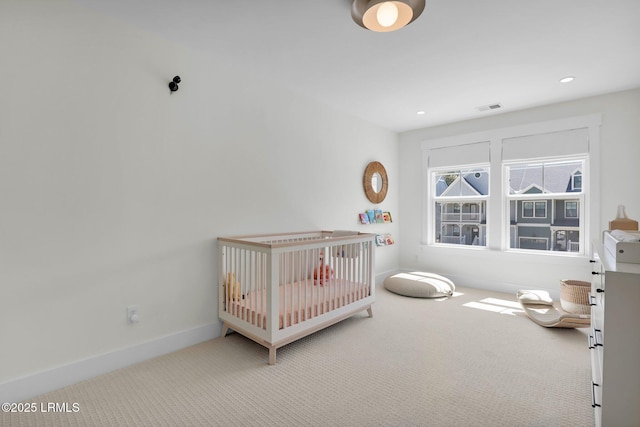 bedroom featuring visible vents, carpet, baseboards, recessed lighting, and a nursery area