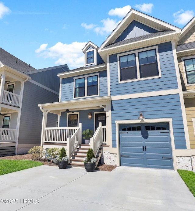 view of property with driveway, a garage, board and batten siding, and a porch