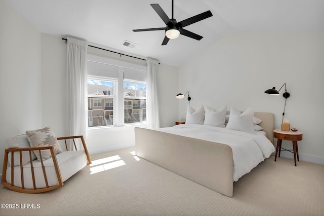 bedroom featuring lofted ceiling, ceiling fan, visible vents, and light carpet
