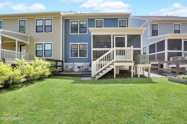 back of house with a sunroom and a yard
