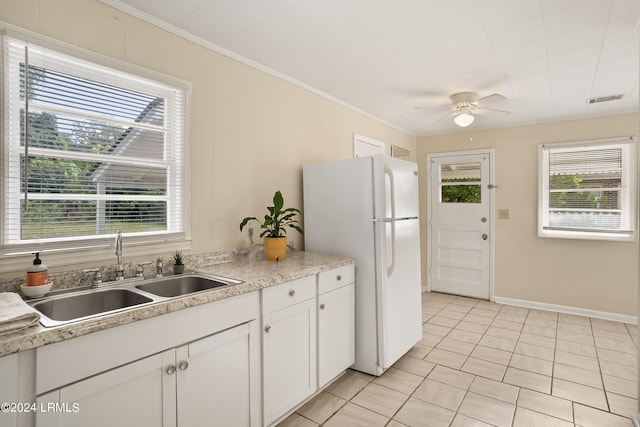 kitchen with sink, light tile patterned floors, white cabinets, and white fridge