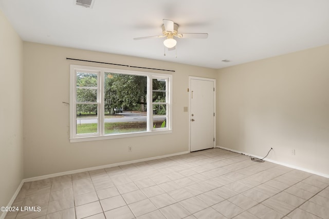 unfurnished room featuring light tile patterned floors and ceiling fan