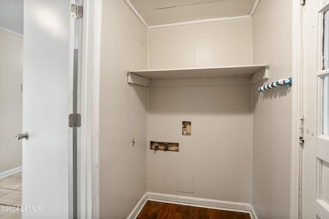 laundry area featuring hardwood / wood-style floors, crown molding, washer hookup, and wooden walls