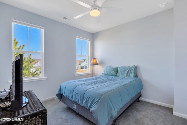 carpeted bedroom with baseboards, visible vents, and a ceiling fan