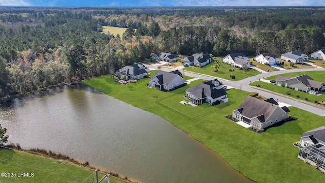 aerial view featuring a water view, a wooded view, and a residential view